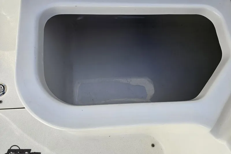 Slide: The Image of Storage compartment on a 2010 Chaparral 276 SSX boat, white interior. - 46
