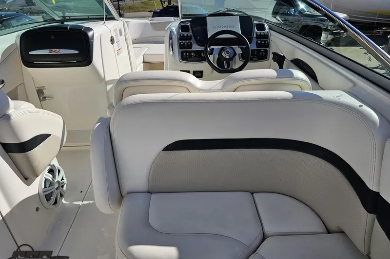 Slide: The Image of Interior of a 2010 Chaparral 276 SSX boat with white seating and modern dashboard. - 47