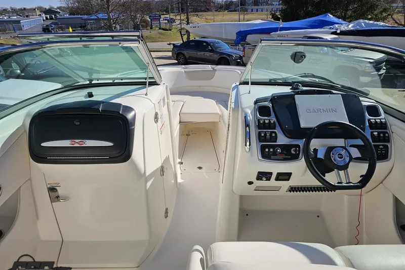 Slide: The Image of 2010 Chaparral 276 SSX boat interior with Garmin navigation system and steering wheel. - 48