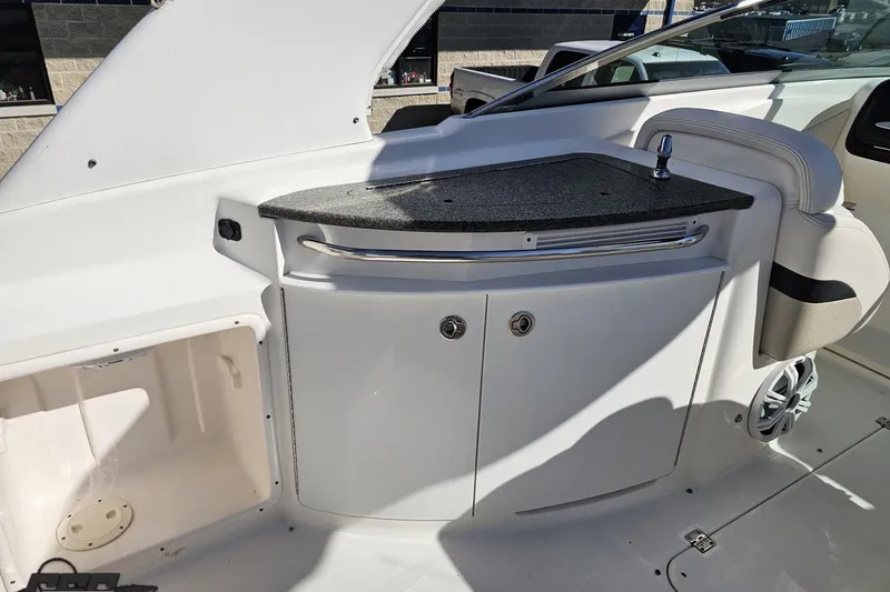 Slide: The Image of 2010 Chaparral 276 SSX boat interior with sleek countertop and storage cabinets. - 51