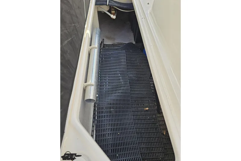 Slide: The Image of Interior view of a 2010 Chaparral 276 SSX boat storage compartment with black mat. - 55