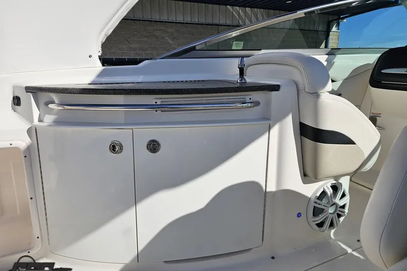 Slide: The Image of 2010 Chaparral 276 SSX boat interior with storage cabinets and seating. - 56