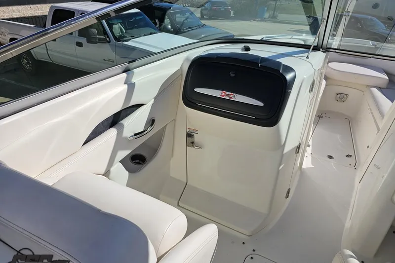 Slide: The Image of Interior view of 2010 Chaparral 276 SSX boat, featuring white seating and dashboard. - 58