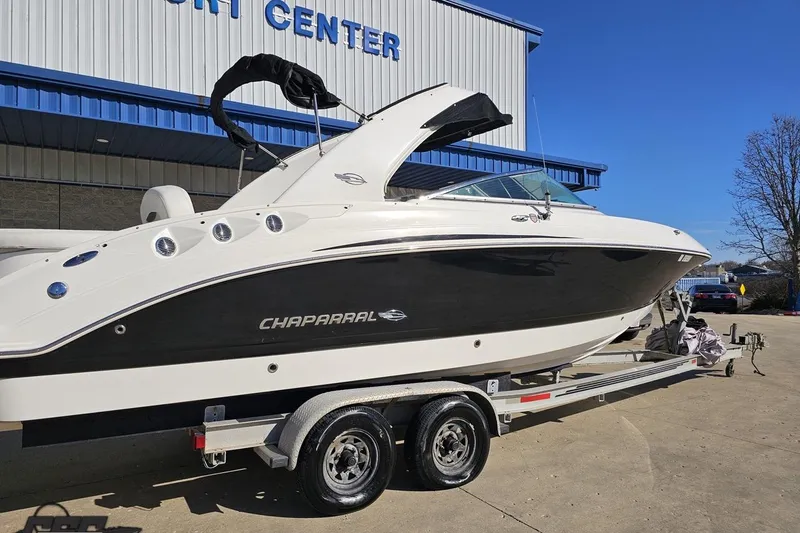 Slide: The Image of 2010 Chaparral 276 SSX boat on trailer outside a marine center. - 6