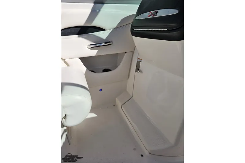 Slide: The Image of Interior view of a 2010 Chaparral 276 SSX boat, featuring sleek white design. - 60