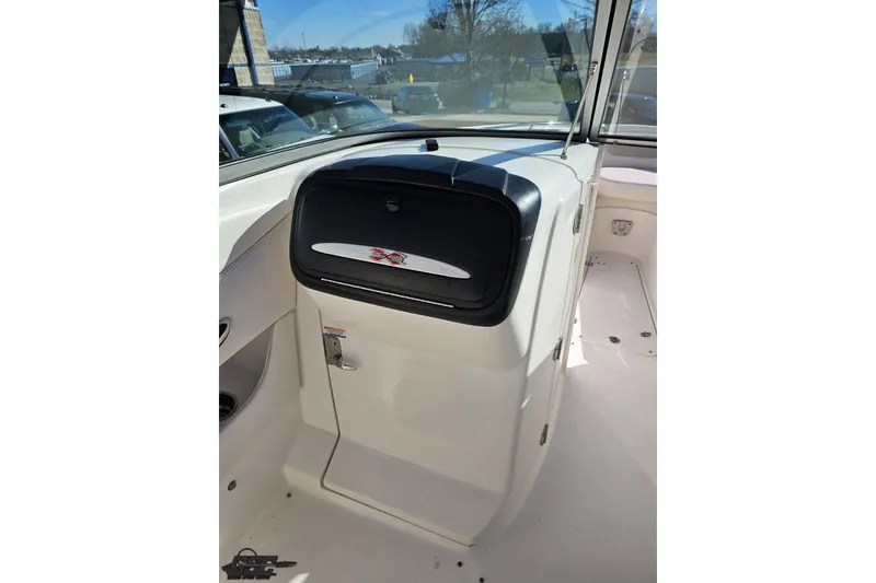 Slide: The Image of 2010 Chaparral 276 SSX boat interior with storage compartment and sleek design. - 61