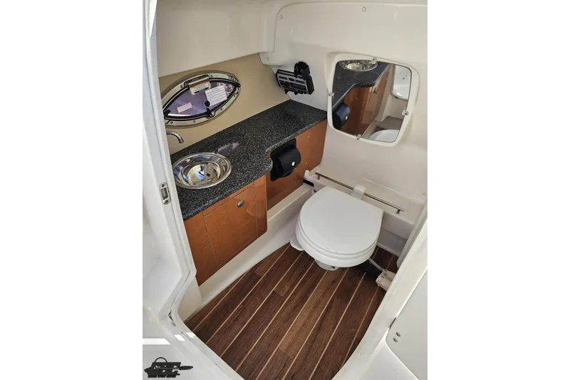 Slide: The Image of 2010 Chaparral 276 SSX boat bathroom with sink, toilet, and wood flooring. - 62