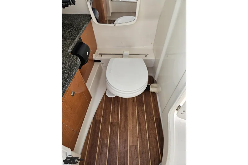 Slide: The Image of 2010 Chaparral 276 SSX boat bathroom with wood flooring and compact design. - 63
