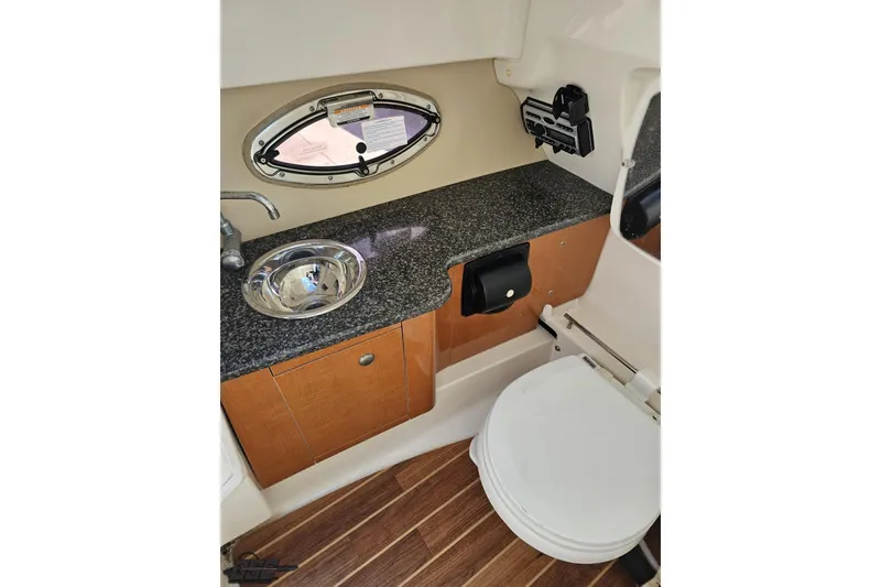 Slide: The Image of 2010 Chaparral 276 SSX boat bathroom with sink, countertop, and toilet. - 64