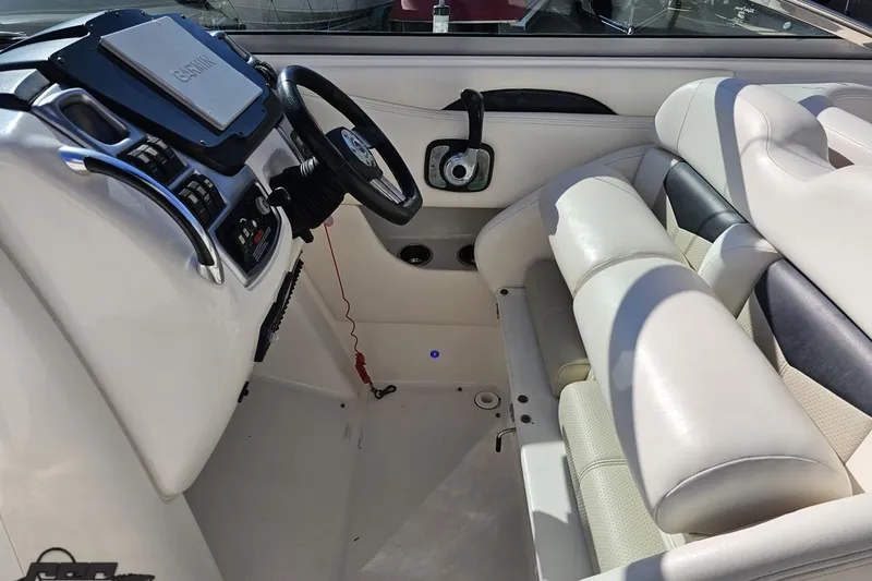 Slide: The Image of 2010 Chaparral 276 SSX boat interior with steering wheel and seating. - 66