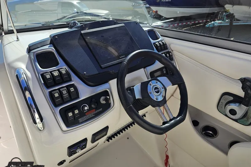 Slide: The Image of 2010 Chaparral 276 SSX boat dashboard with steering wheel and control panel. - 67