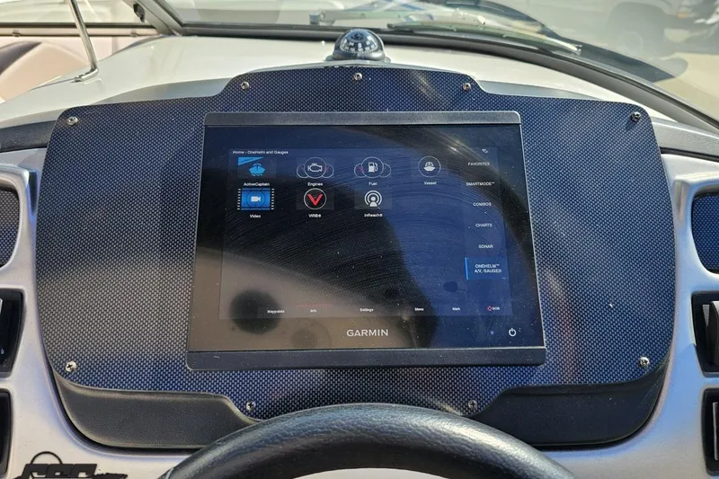 Slide: The Image of Dashboard of a 2010 Chaparral 276 SSX boat featuring a Garmin navigation system. - 68