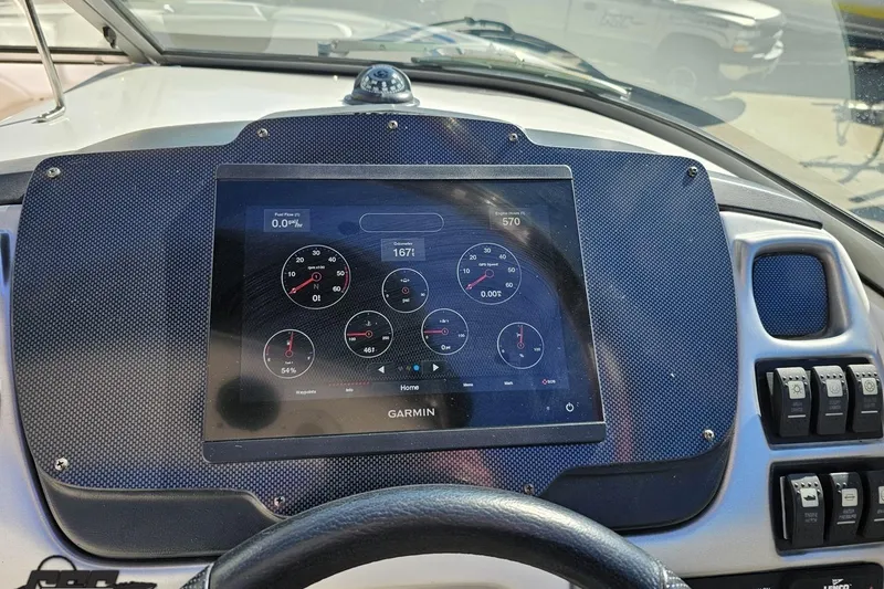 Slide: The Image of Dashboard of a 2010 Chaparral 276 SSX boat featuring a Garmin display. - 69