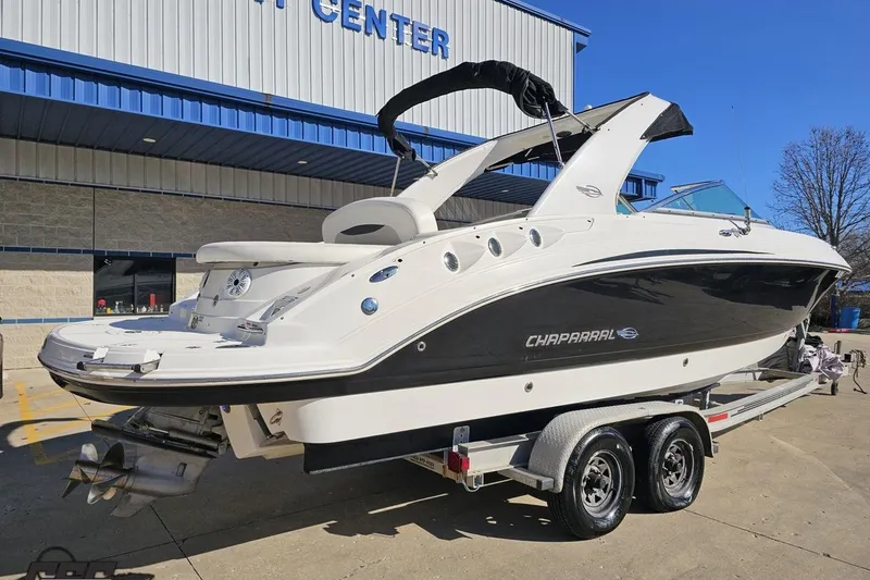 Slide: The Image of 2010 Chaparral 276 SSX boat on trailer, parked outside a building. - 7