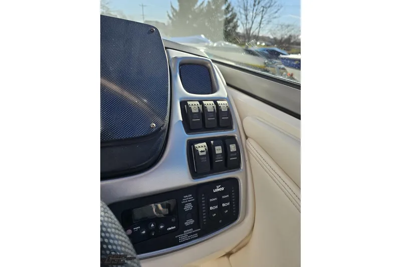 Slide: The Image of Control panel of a 2010 Chaparral 276 SSX boat with switches and trim controls. - 72