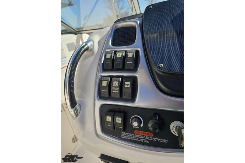 Slide: The Image of Control panel of a 2010 Chaparral 276 SSX boat with switches and warning label. - 73
