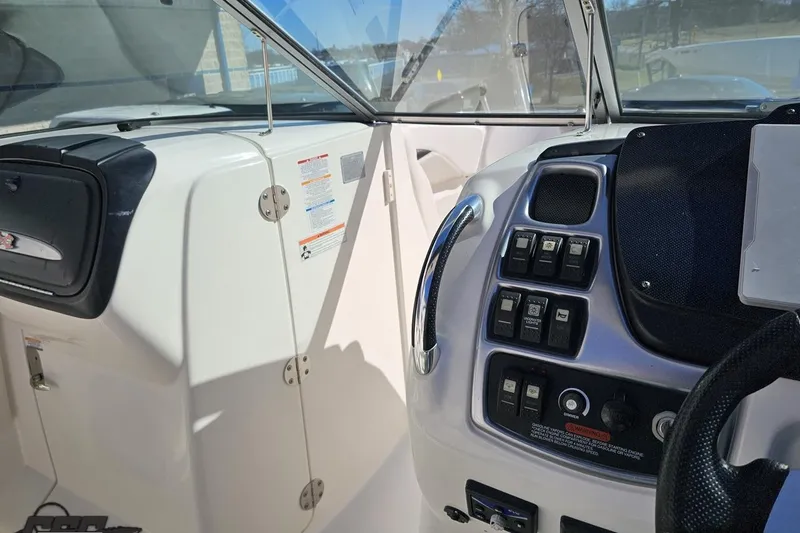 Slide: The Image of 2010 Chaparral 276 SSX boat dashboard with control panel and steering wheel. - 74