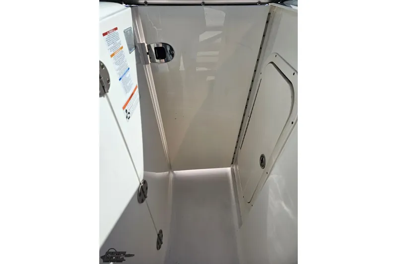 Slide: The Image of Interior view of a 2010 Chaparral 276 SSX boat compartment with white finish. - 76