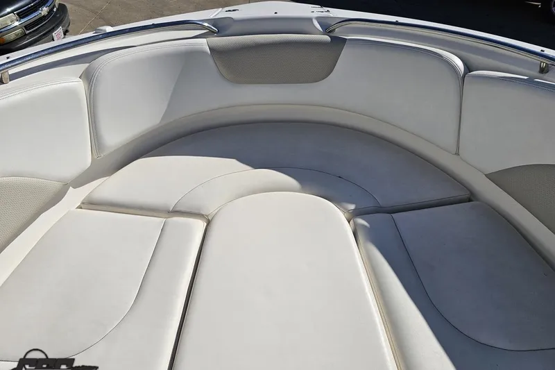 Slide: The Image of Bow seating area of a 2010 Chaparral 276 SSX boat, featuring white cushioned seats. - 80