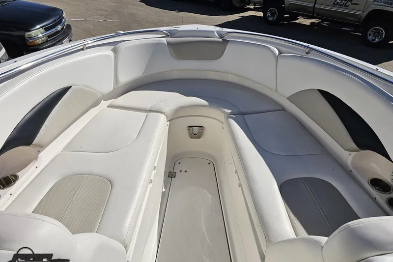 Slide: The Image of 2010 Chaparral 276 SSX boat interior with spacious white seating and cup holders. - 81