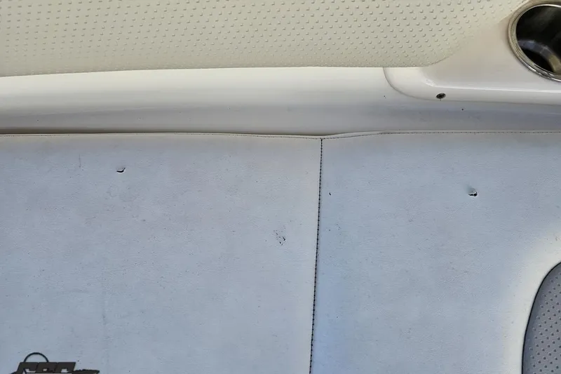 Slide: The Image of Interior detail of 2010 Chaparral 276 SSX boat, featuring upholstery and cup holder. - 86