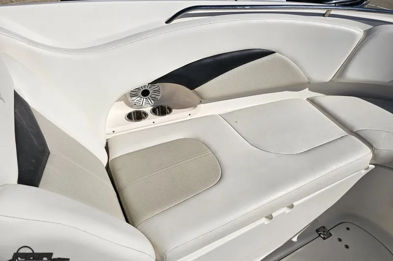 Slide: The Image of 2010 Chaparral 276 SSX boat interior with white seating and cup holders. - 88