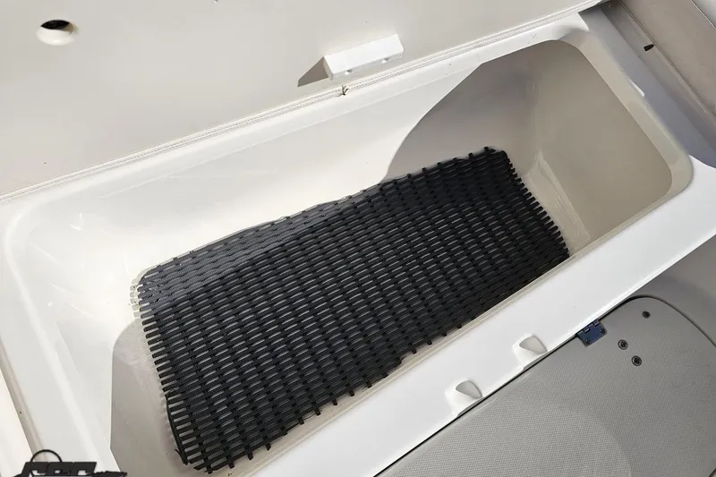 Slide: The Image of Storage compartment of 2010 Chaparral 276 SSX boat with black mat inside. - 90