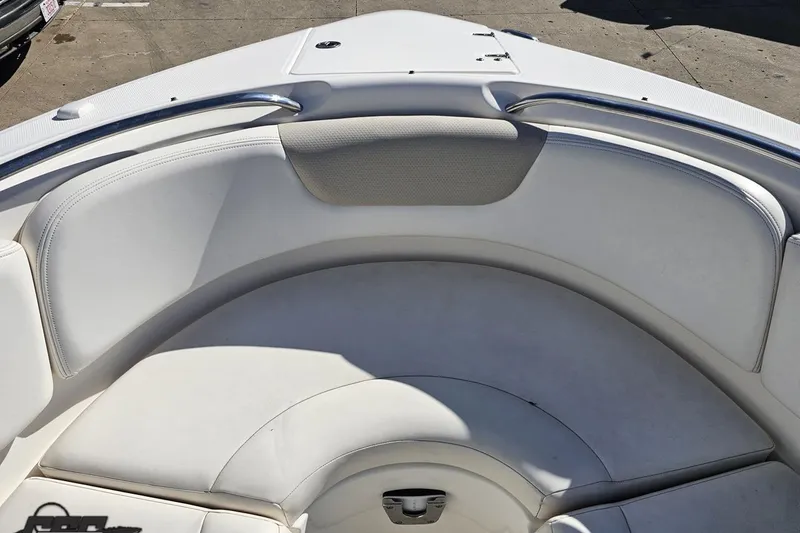 Slide: The Image of 2010 Chaparral 276 SSX boat interior with white cushioned seating. - 91