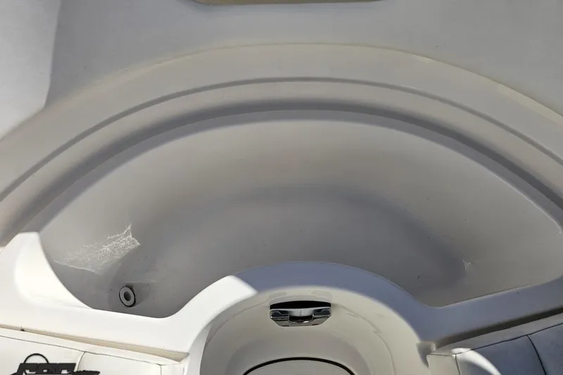 Slide: The Image of 2010 Chaparral 276 SSX boat interior detail, showcasing clean, white fiberglass surface. - 93