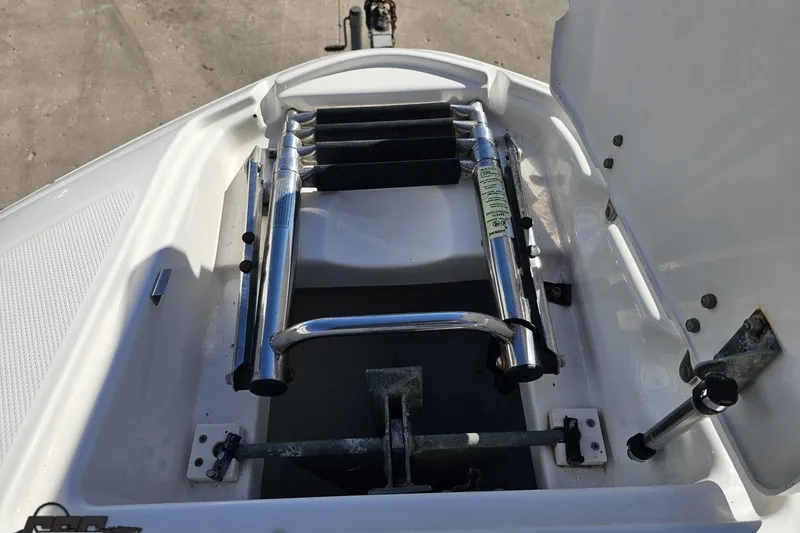 Slide: The Image of 2010 Chaparral 276 SSX boat ladder and storage compartment. - 95