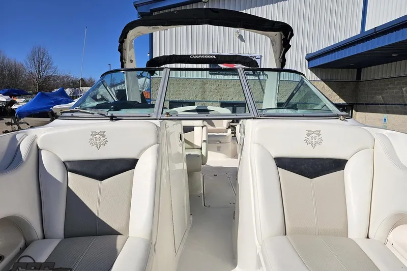 Slide: The Image of 2010 Chaparral 276 SSX boat interior with white seating and windshield. - 96