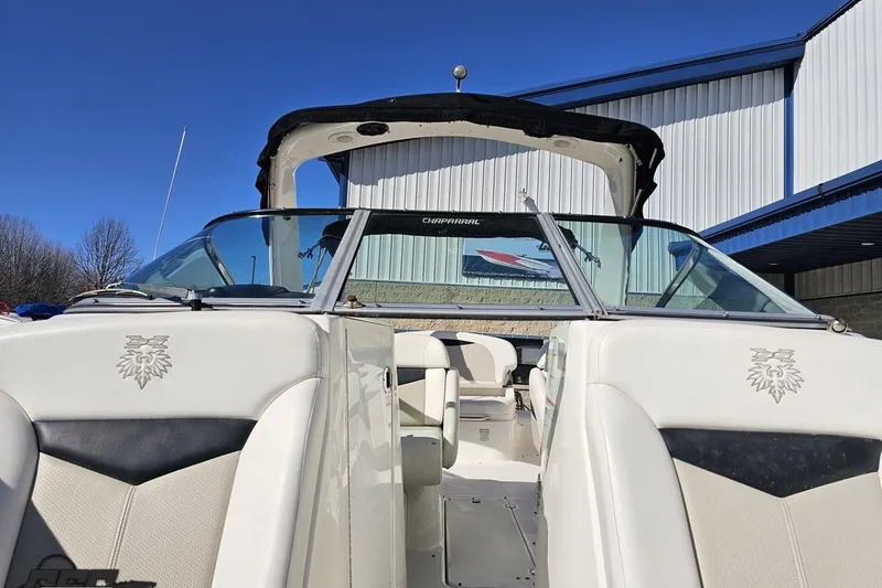Slide: The Image of 2010 Chaparral 276 SSX boat with open cockpit, parked near a building. - 97