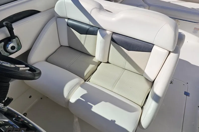 Slide: The Image of 2010 Chaparral 276 SSX boat interior with white and gray seating. - 99