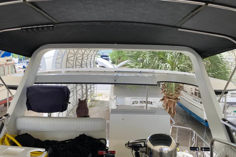 Slide: The Image of Interior view of a 1989 Knight & Carver 3807 yacht with covered seating area. - 11