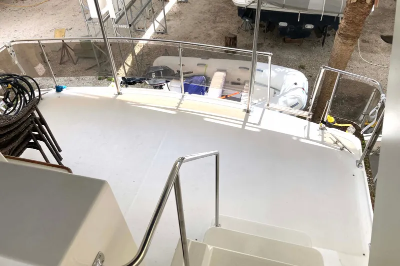 Slide: The Image of Deck view of 1989 Knight & Carver 3807 yacht with railing and outdoor equipment. - 12