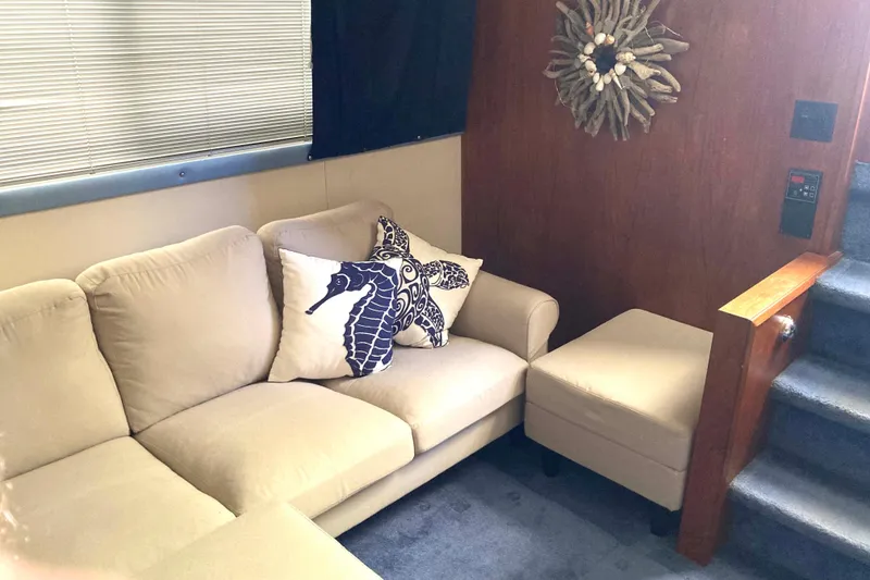 Slide: The Image of Interior of 1989 Knight & Carver 3807 yacht with beige sofa and seahorse pillow. - 17