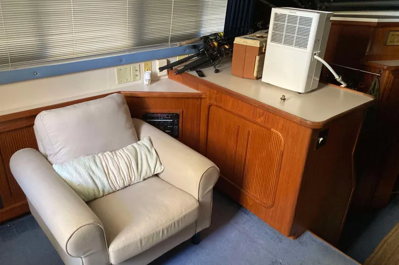 Slide: The Image of Cozy cabin interior of 1989 Knight & Carver 3807 yacht with armchair and dehumidifier. - 18