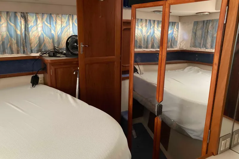 Slide: The Image of Cozy cabin interior of 1989 Knight & Carver 3807 yacht with mirrored closet. - 23