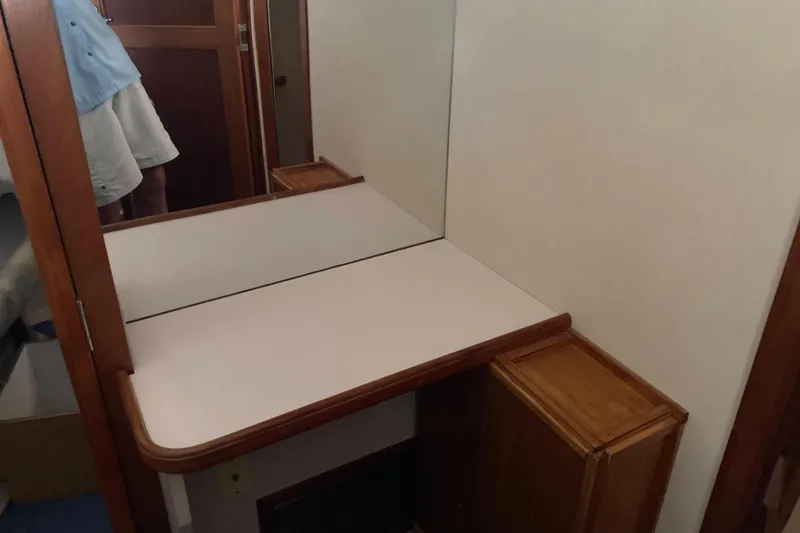 Slide: The Image of Interior of 1989 Knight & Carver 3807 yacht with wooden cabinetry and mirror. - 26