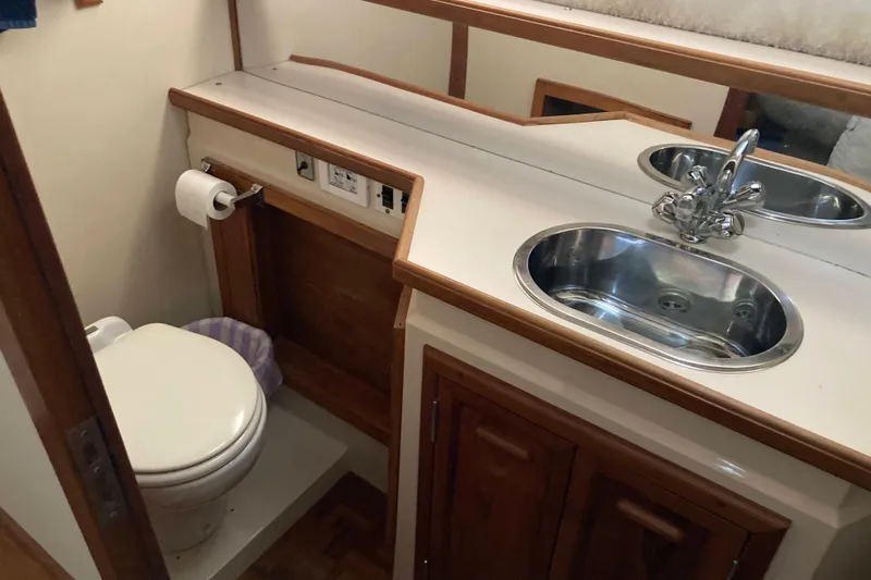 Slide: The Image of Compact bathroom in 1989 Knight & Carver 3807 yacht with sink and toilet. - 27