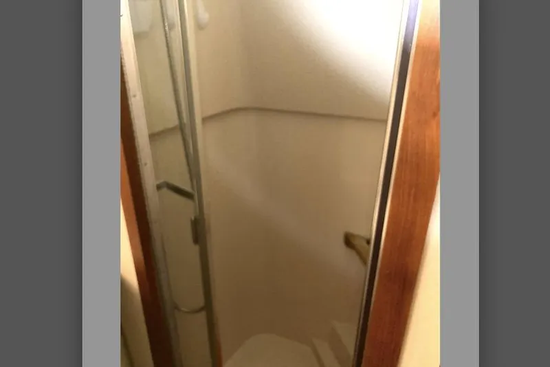 Slide: The Image of Compact shower area inside a 1989 Knight & Carver 3807 boat. - 28