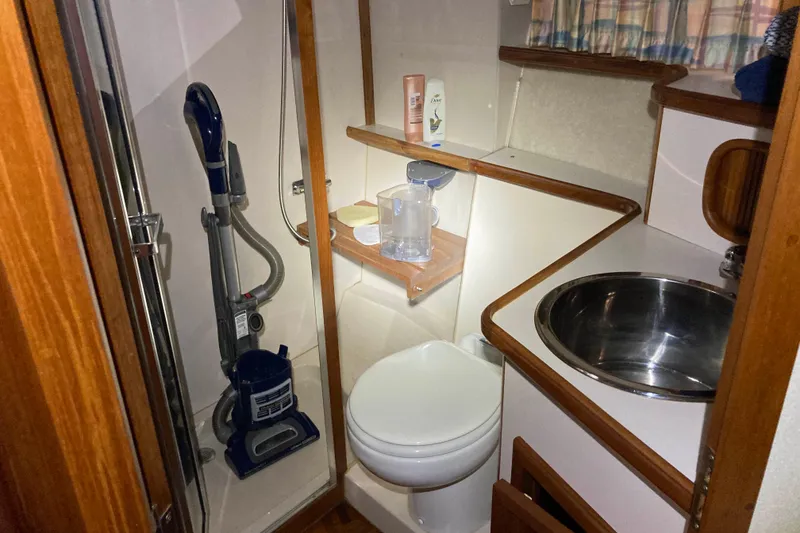 Slide: The Image of Compact bathroom in 1989 Knight & Carver 3807 yacht with shower, sink, and toilet. - 30