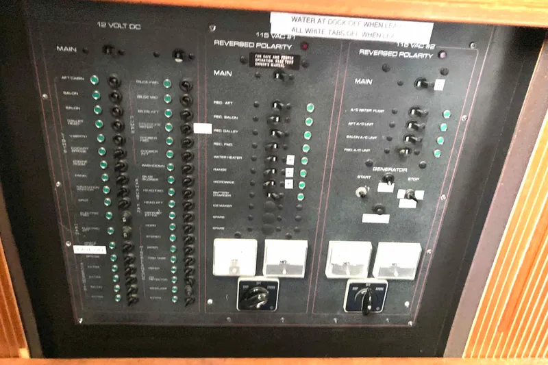 Slide: The Image of Electrical control panel of a 1989 Knight & Carver 3807 boat, featuring various switches and indicators. - 31