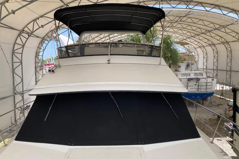 Slide: The Image of 1989 Knight & Carver 3807 yacht under a protective canopy in a boatyard. - 5