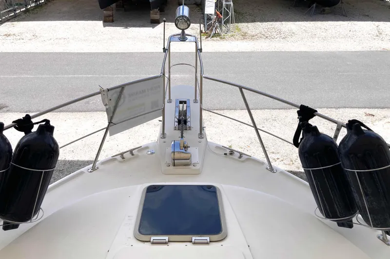 Slide: The Image of Bow view of 1989 Knight & Carver 3807 yacht with fenders and hatch. - 6