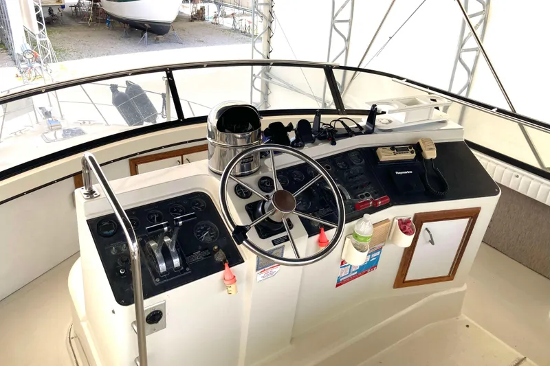 Slide: The Image of Helm of 1989 Knight & Carver 3807 yacht with steering wheel and navigation controls. - 7