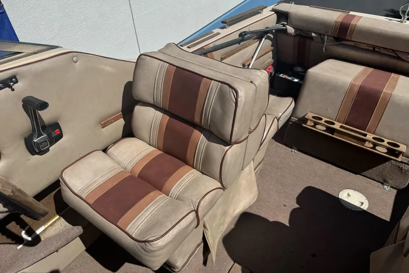 Slide: The Image of 1985 Invader 20 boat interior with beige and brown cushioned seats. - 16
