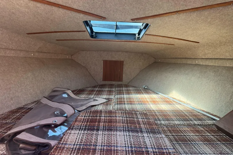 Slide: The Image of Interior cabin of 1985 Invader 20 boat with plaid upholstery and skylight. - 19