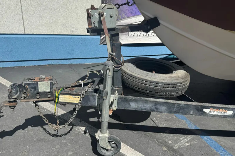 Slide: The Image of Trailer hitch of a 1985 Invader 20 boat with spare tire and wiring visible. - 4