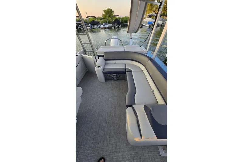 Slide: The Image of 2023 Avalon Catalina 2585 CRFS Funship interior with spacious seating and scenic water view. - 13